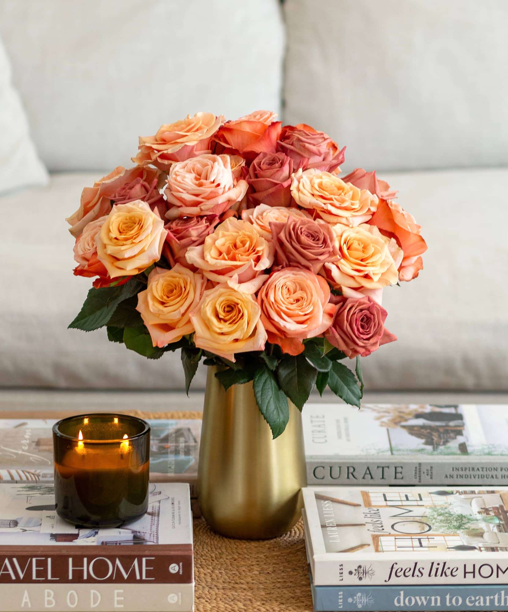 Luxurious bouquet of peach and pink roses in a stylish vase, enhancing any living space.