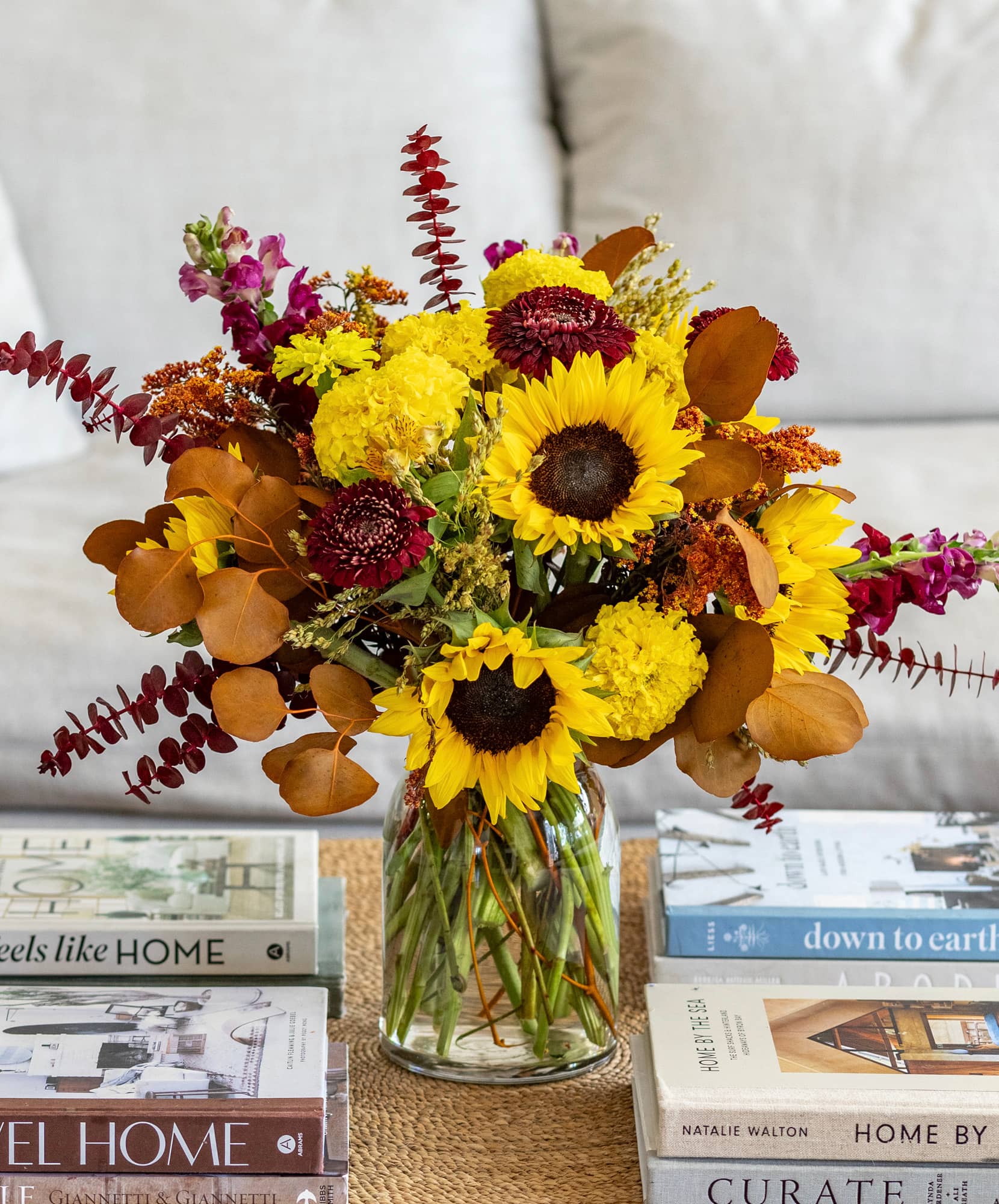 Vibrant sunflower and autumn flower arrangement in a stylish vase for home decor.