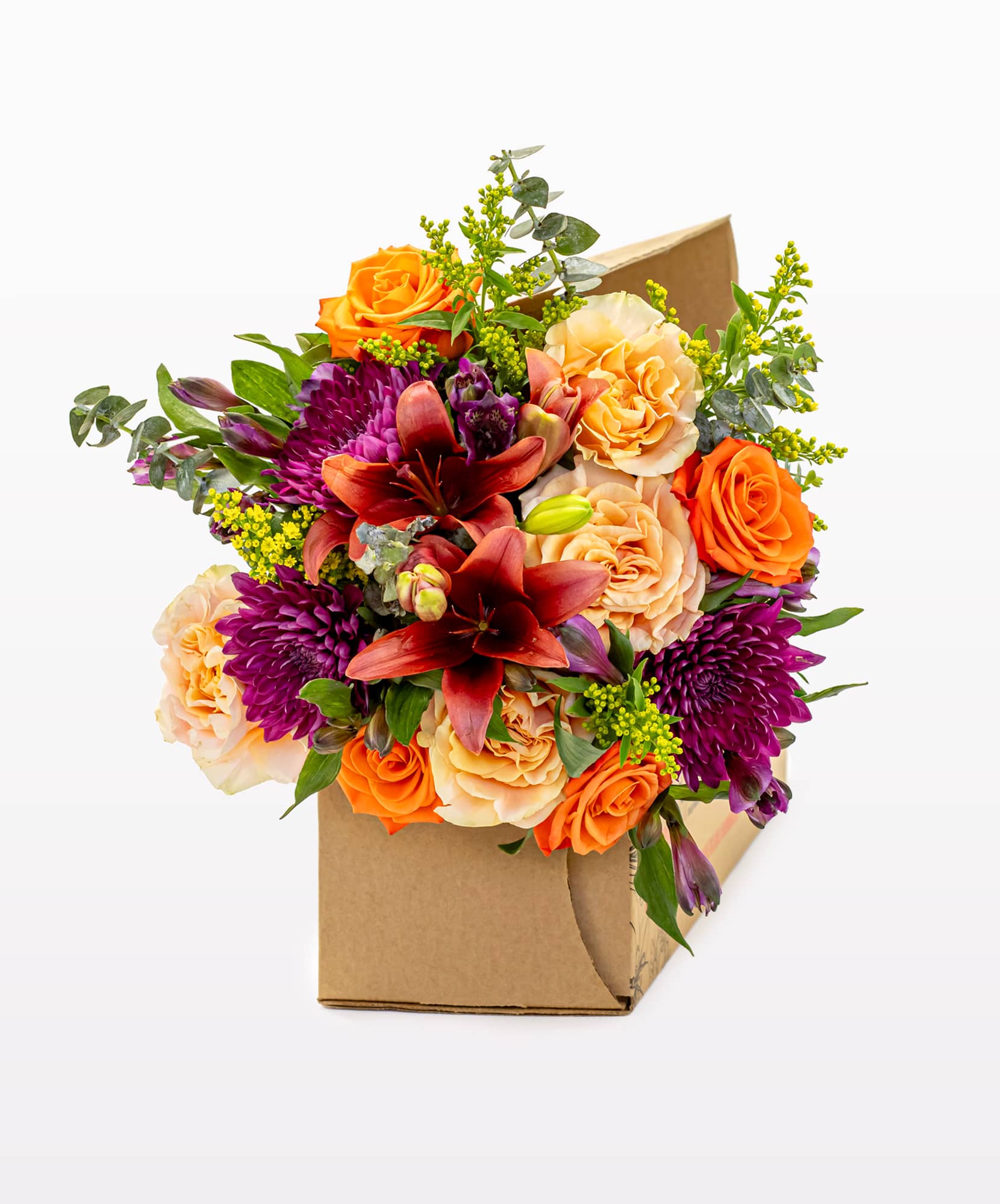 Vibrant bouquet featuring orange roses, lilies, and purple chrysanthemums in a box.